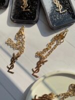 قاب گوشی آیفون 16 پرومکس طرح YSL مشکی آکواریومی با آویز